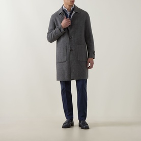 Model wearing Eleventy coat in grigio medio melange, styled with blue trousers and dark loafers