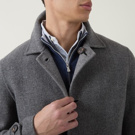 Model wearing Eleventy grigio medio melange wool coat, styled with navy zip-neck knitwear and white collared shirt visible beneath.