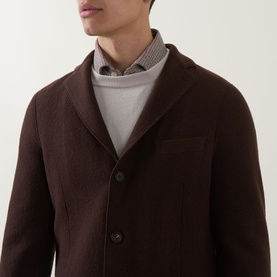 Model wearing Eleventy Cashmere Knitted Sweater in Sabbia e Bianco, fine check pattern, button-up collar detail visible at neckline