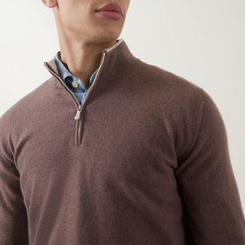 Model wearing Eleventy cashmere half-zip jumper in Moro E Sabbia, styled over a blue patterned shirt, close-up detail view.