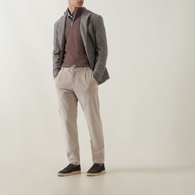 Model wearing Eleventy Moro E Sabbia cashmere half zip, styled with grey blazer, beige trousers and dark suede shoes