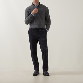 Model wearing Eleventy cashmere half-zip in grey, styled with a blue shirt and dark tailored trousers with black leather shoes.