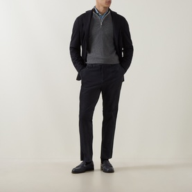 Model wearing Eleventy cashmere half-zip in grey, styled with a black cardigan, blue shirt, and black tailored trousers.