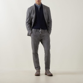 Model wearing Eleventy Cashmere Half-Zip Sweater in blue and light grey, styled with grey blazer, trousers and suede shoes.
