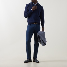 Model wearing Eleventy Dark Blue Wool Half Zip, styled with blue trousers, white shirt, and carrying a grey jacket.