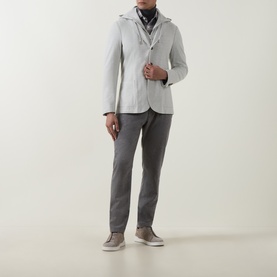 Model wearing Eleventy light grey melange jacket with hood detail, styled with grey trousers and taupe trainers