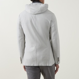 Model wearing Eleventy jacket in Grigio Chiaro Melange, rear view showing attached hood and tailored back seams, styled with grey trousers.