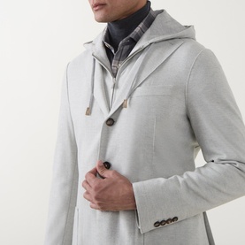 Model wearing Eleventy hooded jacket in grigio chiaro melange, styled over dark turtleneck, button-front with drawstring hood detail