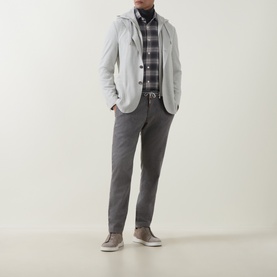 Model wearing Eleventy Grigio Chiaro Melange jacket, styled with checked shirt, grey trousers and taupe suede trainers.