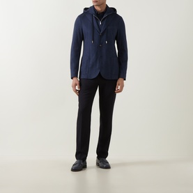 Model wearing Eleventy blue hooded blazer jacket with black trousers and navy trainers.