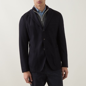 Model wearing Eleventy blue wool-blend jacket with three-button front, styled over a grey zip-through and light blue shirt