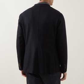 Model wearing Eleventy blue wool-blend jacket, rear view showing clean back seam and two-button cuffs.