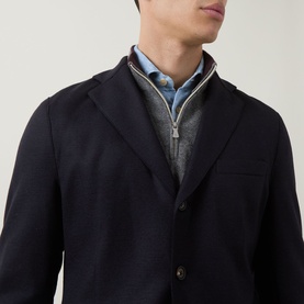Model wearing Eleventy blue wool-blend jacket, styled with grey zip-neck sweatshirt and light blue shirt underneath.