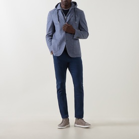 Model wearing Eleventy light blue cotton-wool jacket with hood detail, styled with navy trousers and grey slip-on trainers