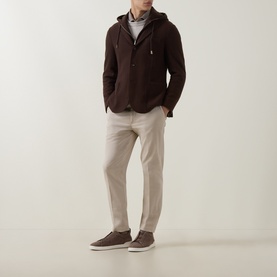 Model wearing Eleventy brown wool jacket with hood detail, styled with grey top, beige trousers and brown suede trainers