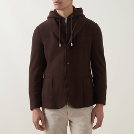 Model wearing Eleventy brown wool jacket with detachable hood, three-button front and patch pockets, styled with light beige trousers