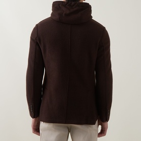 Model wearing Eleventy brown wool hooded jacket, back view, styled with light grey trousers