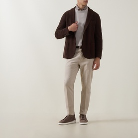 Model wearing Eleventy brown wool jacket styled with grey jumper, cream trousers and dark brown suede trainers