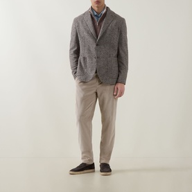 Model wearing Eleventy Check Single-Breasted Blazer in brown, styled with beige trousers, a knit layer, and dark navy trainers.