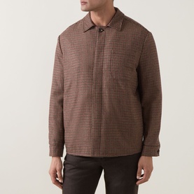 Model wearing Eleventy red houndstooth wool-blend jacket with spread collar, zip front, and chest pocket, styled with dark trousers.