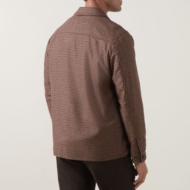 Model wearing Eleventy red houndstooth wool-blend jacket, back view, styled with dark brown trousers.