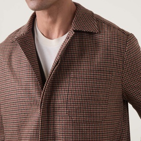 Model wearing Eleventy red houndstooth wool jacket with open collar, styled over a white crew-neck T-shirt