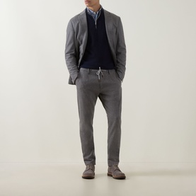 Model wearing Eleventy Brushed Single-Breasted Blazer in grey, styled with navy knitwear, grey trousers and suede shoes.