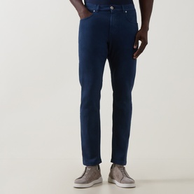 Model wearing Eleventy blue slim-fit jeans in cotton-elastane blend, styled with grey suede lace-up shoes.