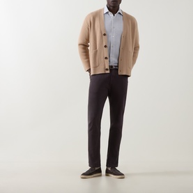 Model wearing Eleventy Burgundy Jeans in slim fit, styled with camel cardigan, blue shirt and dark trainers