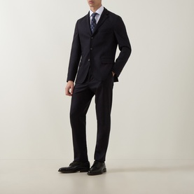 Model wearing Eleventy Single-Breasted Two-Piece Suit in blue wool-cashmere blend, styled with white shirt, patterned tie and black shoes.