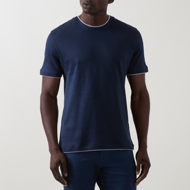 Model wearing Eleventy navy blue cotton T-shirt with white contrast tipping at crew neck and sleeve cuffs, styled with blue jeans