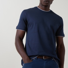 Model wearing Eleventy navy cotton T-shirt with contrast white tipping at crew neck and cuffs, styled with navy trousers and brown belt