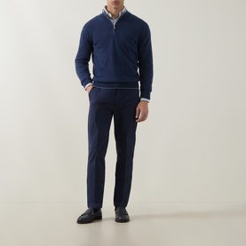 Model wearing Eleventy blue cotton-elastane trousers, styled with a navy half-zip jumper and black loafers.