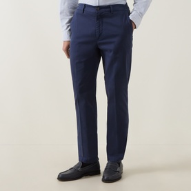 Model wearing Eleventy blue cotton-elastane trousers with a slim fit, styled with a light blue shirt and black loafers.