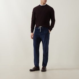 Model wearing Eleventy Drawstring Corduroy Trousers in blue with dark burgundy crewneck sweater and brown leather shoes.
