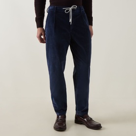 Model wearing Eleventy Drawstring Corduroy Trousers in blue with elasticated drawstring waist, styled with black turtleneck and brown loafers.