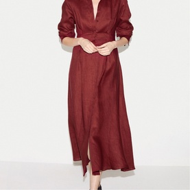 Model wearing deep red midi shirt dress with V-neckline, rolled sleeves, and front split