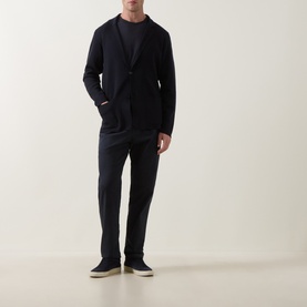 Model wearing Slowear navy virgin wool cardigan, styled with matching navy trousers and dark crew-neck top, navy slip-on shoes.