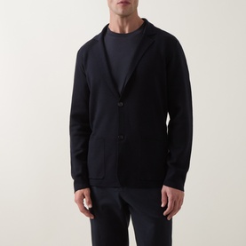 Model wearing Slowear navy virgin wool cardigan with notch lapels and button front, styled with matching navy trousers and crew-neck top.