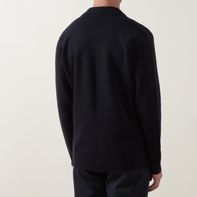 Model wearing Slowear navy virgin wool cardigan, rear view showing clean back seam and ribbed collar detail