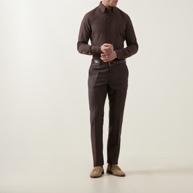 Model wearing Slowear Solid Single-Cuff Shirt in dark brown with matching trousers, brown belt, and taupe suede loafers.