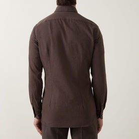 Model wearing Slowear Solid Single-Cuff Shirt in dark brown cotton, back view showing knife pleats and curved hemline.