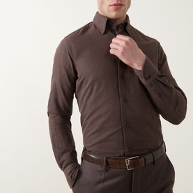 Model wearing Slowear Solid Single-Cuff Shirt in dark brown cotton with Kent collar, styled with matching brown trousers and belt.