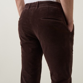 Model wearing Slowear brown cotton corduroy casual trousers, rear view showing back pockets and belt loops.