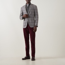 Model wearing Slowear burgundy casual trousers in cotton-elastane, styled with a grey check blazer and dark loafers.