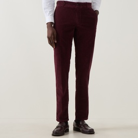 Model wearing Slowear burgundy corduroy casual trousers, styled with a white shirt and brown loafers.