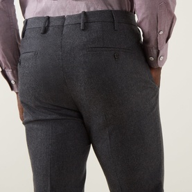 Model wearing Slowear grey wool-cashmere formal trousers, rear view showing back pockets and tailored fit, styled with a mauve shirt.