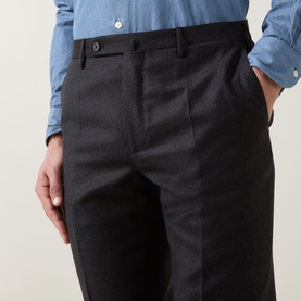 Model wearing Slowear Straight Leg Trousers in charcoal wool-cashmere blend, with buttoned tab waistband and pressed crease. Styled with blue