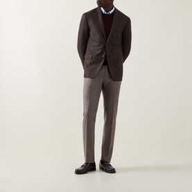 Model wearing Slowear beige formal wool trousers, styled with a dark brown blazer, burgundy jumper and dark leather shoes.