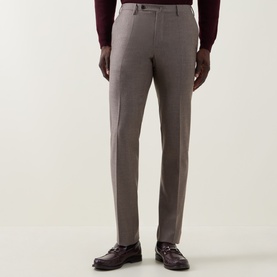 Model wearing Slowear beige formal wool trousers with a tailored straight leg, styled with burgundy loafers and a dark red top.